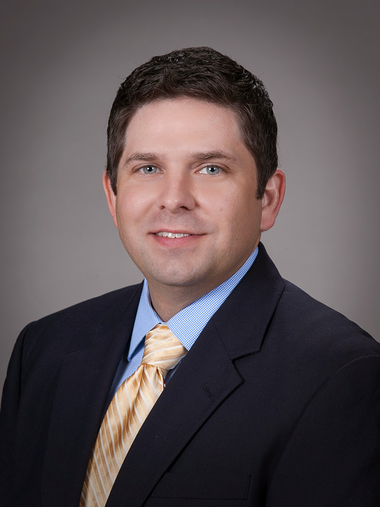 University headshot of Dr. Adam Patterson