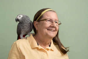 Dr. Janice Boyd and her African gray parrot, Paula