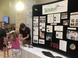 DeBrock works with kids at Schubot Open House Booth