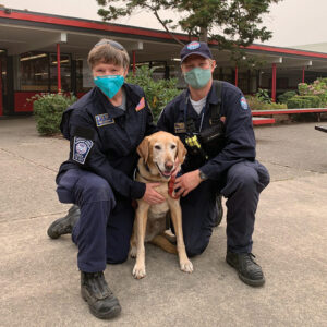 Dr. Deb Zoran poses with Scout and his handler Chad Matchel from Washington Task Force 1 in September 2020.