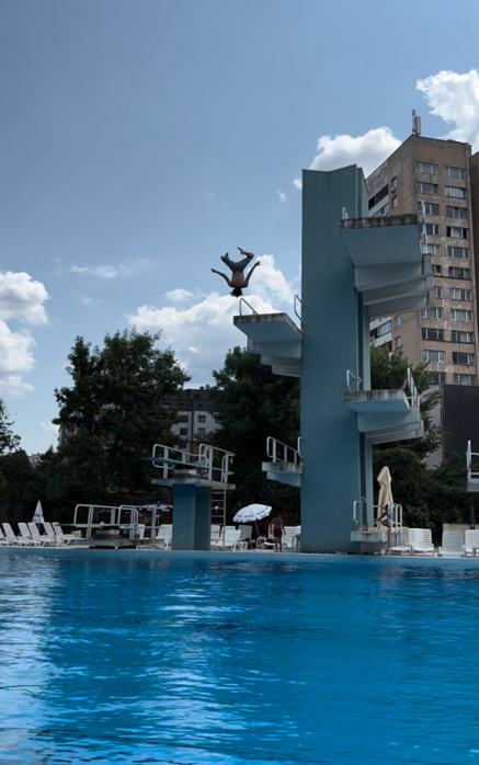 Practicing inverse flips from a 7 meter platform at natatorium.