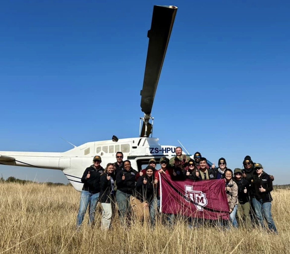 Our group in front of the helicopter after a day of immobilizing rhino.